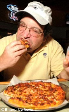 Yummy: David munches on one of his favourite pizzas