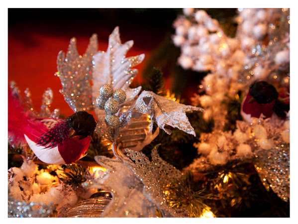 Feathered robins, glittered seeds, glitter edged greenery on a pre-lit artificial wreath