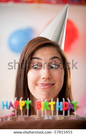 stock photo : Happy girl with a funny face and a happy birthday cake