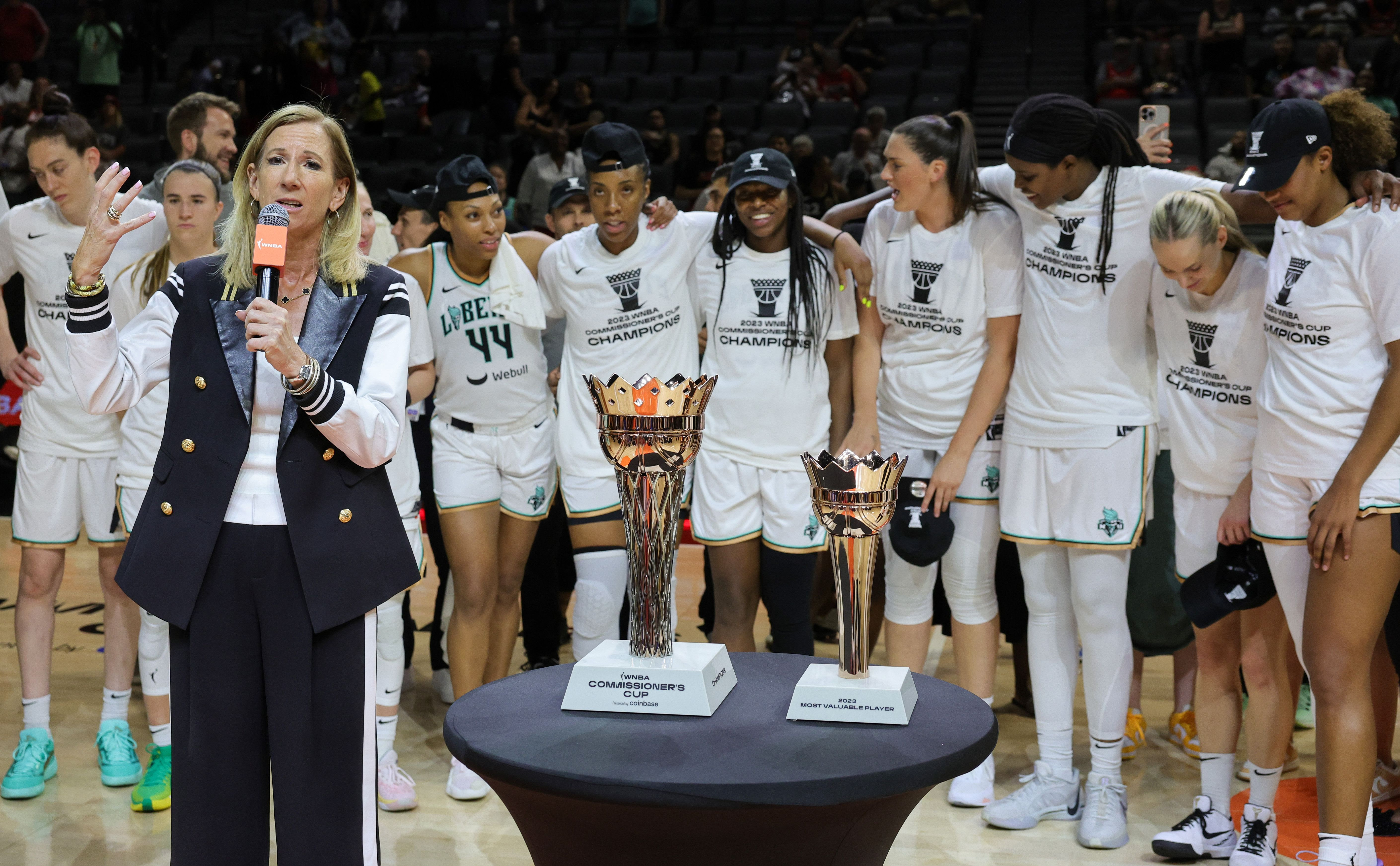WNBA Commissioner Cathy Engelbert presents the New York Liberty with the championship trophy after winning the 2023 Commissioner's Cup in Las Vegas, Nevada. 