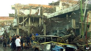 Police inspect devastation in Kuta, Bali on 13 October 2002 after the attacks