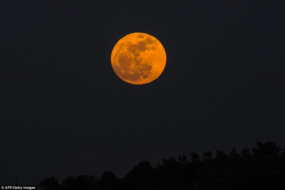 An orange-tinted supermoon beamed above in the skies of Yangon, Myanmar. Orange and red tints that the Sun and Moon sometimes take on are caused by the particles in the Earth's atmosphere