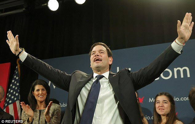 Rubio gestures to supporters alongside South Carolina Governor Nikki Haley (left) at primary night on Saturday