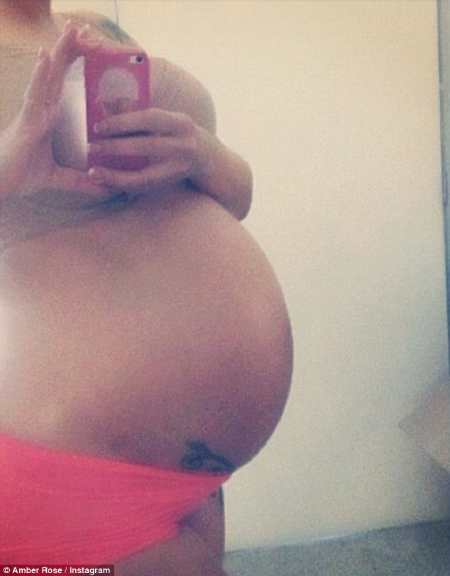 'No stretch marks': Amber Rose is due to give birth any day now and has been proudly showing off her bump on Twitter once again
