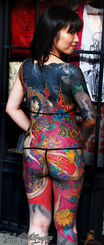 Asian Girl with Tattoos Design Behind 