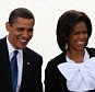 Successful black and mixed-race people, such as Barack and Michelle Obama pictured, are remembered as having a paler skin. Researchers found that stereotypes may cause people to assume an educated black person goes against the norm, and this makes them an 'exception to their race'