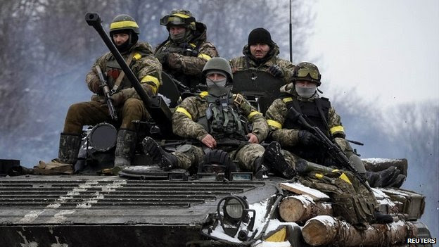 Members of the Ukrainian armed forces ride on an armoured personnel carrier near Debaltseve in eastern Ukraine - 10 February 2015