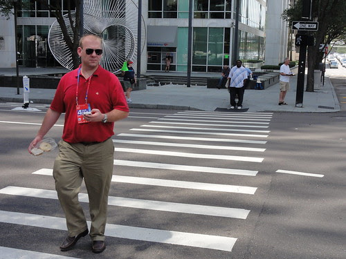 Man on corner reading from bible