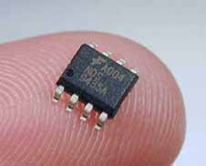 A dual-in-line surface mount package integrated circuit resting on a finger-tip