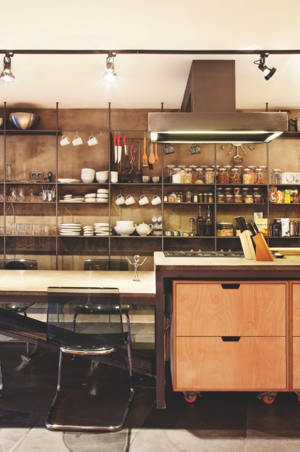Back downstairs a spacious kitchen utilizes the same storage structure for flatware and pantry storage.