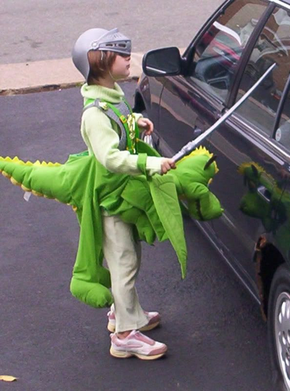 Slaying the evil dragon in her Halloween Costume as a a Knight on a dragon