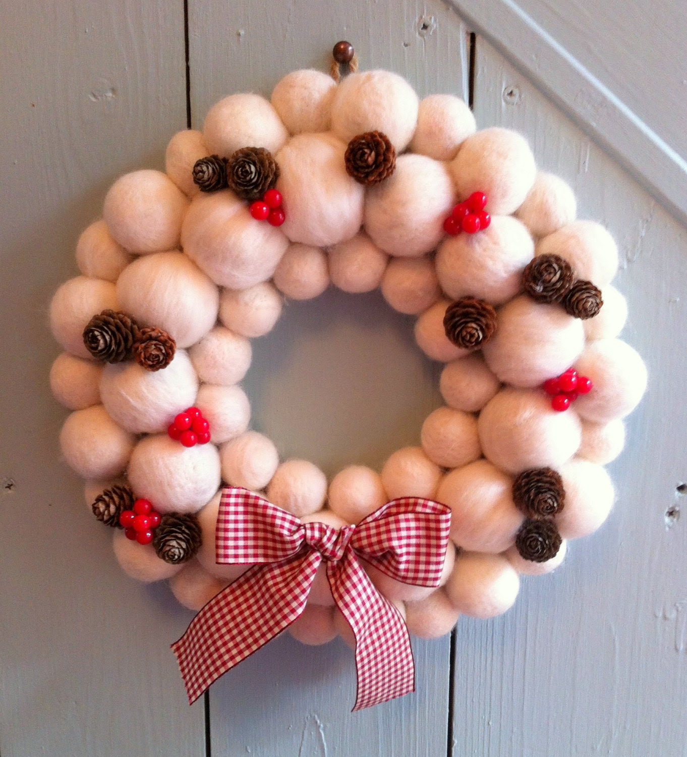 Snowball Wreath handcrafted with soft white merino wool felted balls and berry and pinecone decoration