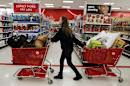 A woman pulls shopping carts through the aisle of a Target store on the shopping day dubbed "Black Friday" in Torrington