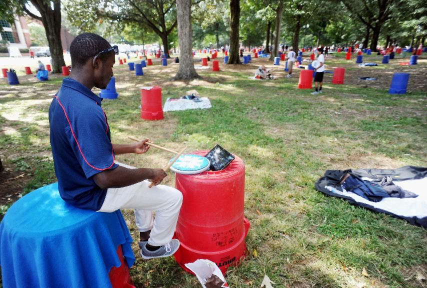 Joseph Reed, a drummer in the University of Mississippi's "Pride of the South" marching band, practices while reserving a tailgating spot in the Grove at the University of Mississippi in Oxford, Miss., Friday, Oct. 3, 2014. Mississippi will host Alabama in an NCAA college football game Saturday. (AP Photo/Oxford Eagle, Bruce Newman)