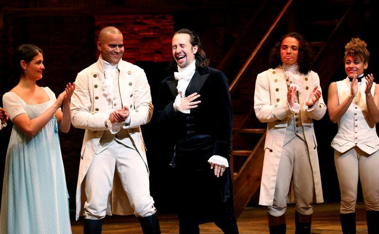 FILE PHOTO -- Actor Lin-Manuel Miranda (C) laughs next to cast members while greeting spectators after taking part in his last performance with Hamilton in New York July 9, 2016. REUTERS/Eduardo Munoz/File Photo