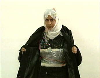 This image taken from television shows Iraqi Sajida Mubarek Atrous al-Rishawi opening her jacket and showing an explosive belt as she confesses on...