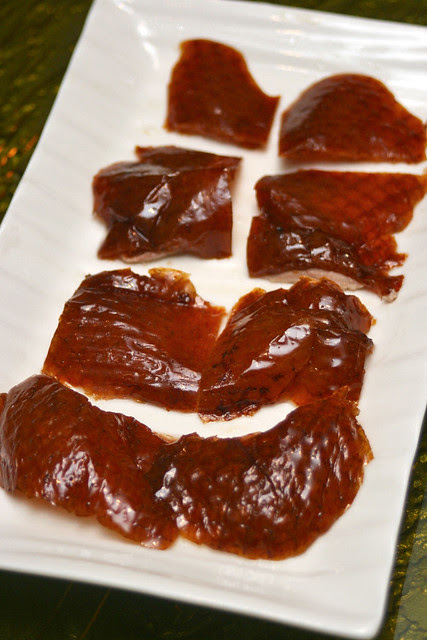 The crispy duck skin is carved and served with a sliver of meat underneath