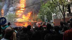 More than 80 fire trucks were called to fight a fire that engulfed a highrise apartment building in China's business centre of Shanghai