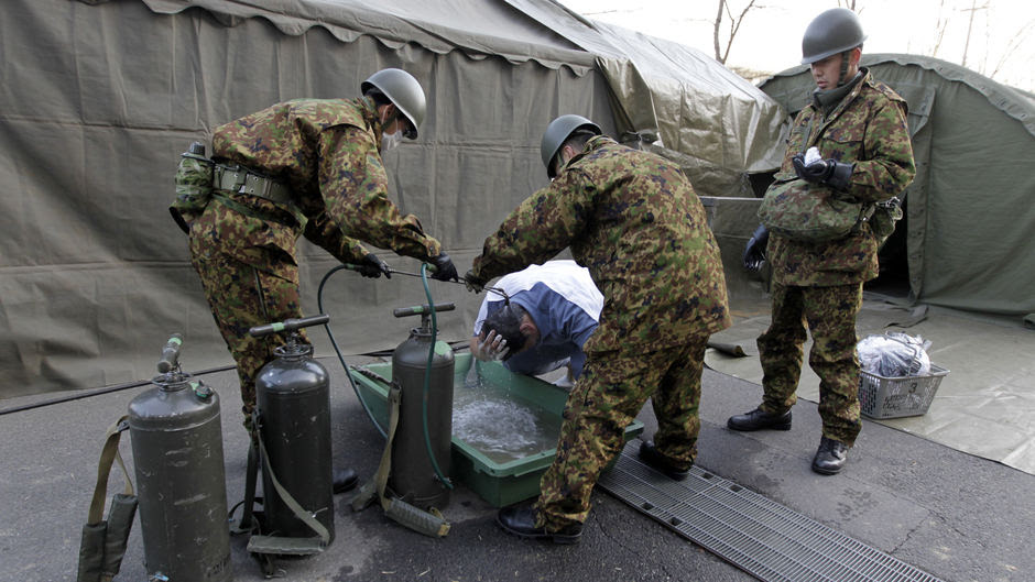 Soldiers clean man possibly exposed to radiation