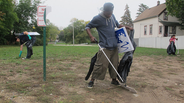 Caption: Volunteers work to clean up the Kinnickinnic River. (Photo by Scottie Lee Meyers)