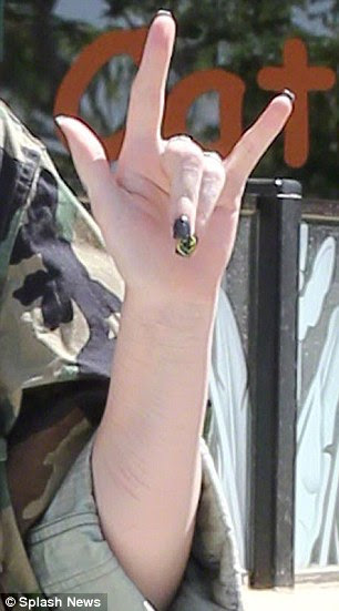 Cry for help? The teenager's scarred forearm could clearly be seen as she raised her arm in the direction of the photographer's camera