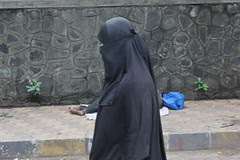 the muslim woman passes the soul of a dying man on the street by firoze shakir photographerno1