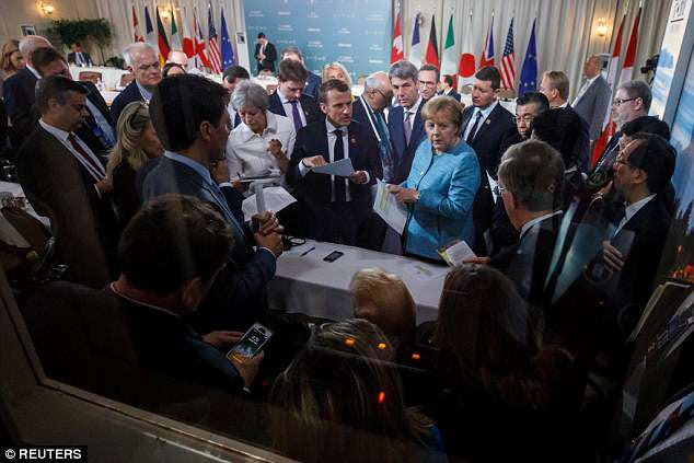 Mrs May (pictured centre left) was among a group of leaders who berated the US president about his imposition of punitive steel tariffs at the G7 summit in Canada
