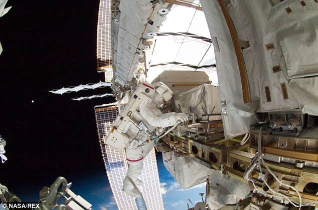 This was the first spacewalk ever for Mr Wiseman and Mr Gerst, and the former's exuberance was evident as he emerged from the hatch into the vast darkness over the Pacific (pictured). 'Wow, looks like we've almost got a full moon out here. It's beautiful,' he said