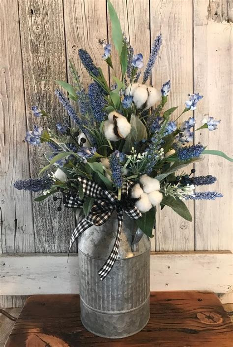 Watch this video for some tips on how to water plants in your yard, including how much water plants should receive and how to measure the water plants recieve. Blueberry Farmhouse Floral Arrangement with Cotton Stems