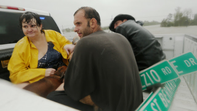 People rest in a rescue truck atop a levee in Plaquemines Parish.