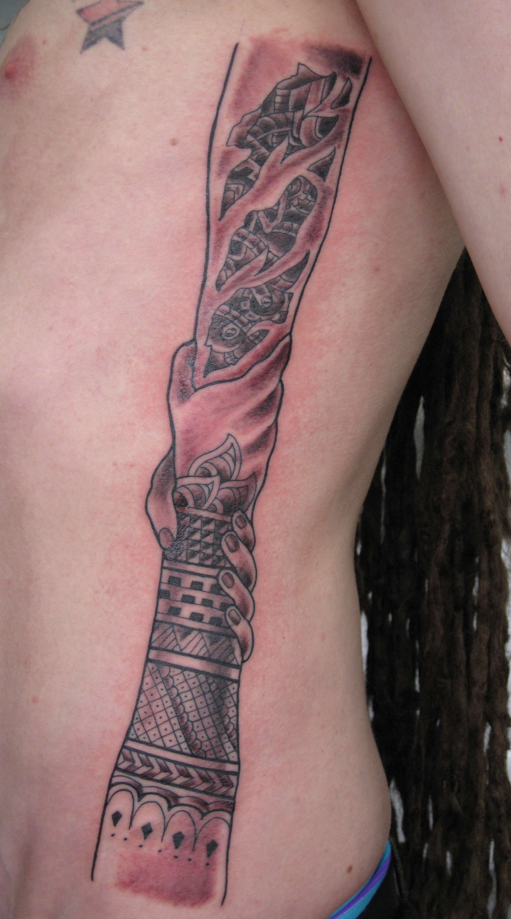 biomech rib tattoo.