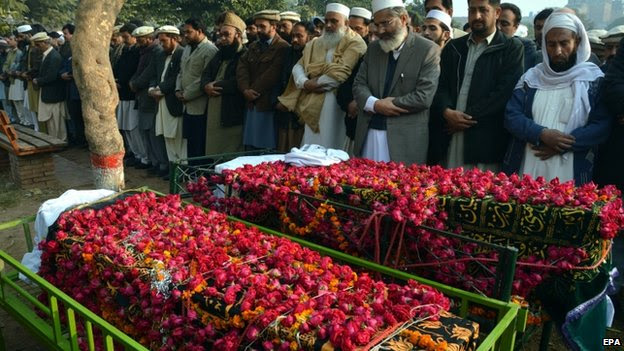 Funeral prayers of two school boys who were killed by Taliban militants at a school run by the Army, in Peshawar, Pakistan, 17 December 2014.