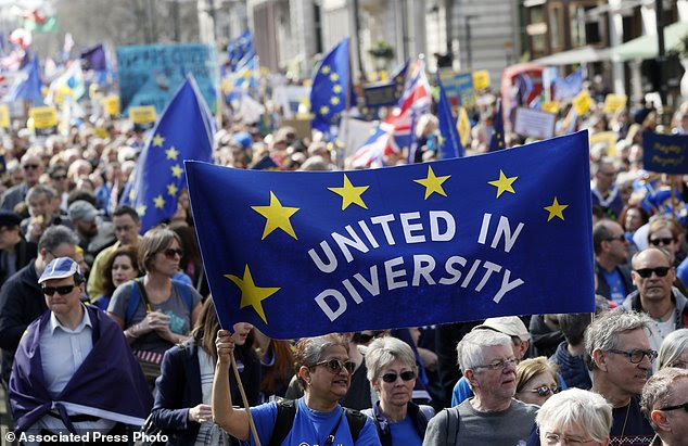 Anti Brexit campaigners carry flags and banners as they march towards Britain's parliament in London, Saturday March 25, 2017. Britain's Prime Minister Theresa May is expected to start the process of leaving the European Union on Wednesday March 29. (AP Photo/Kirsty Wigglesworth)