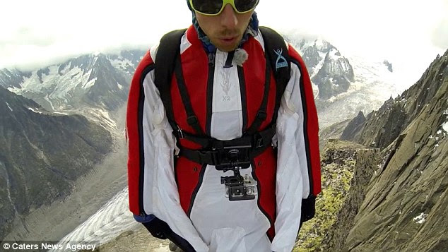 The footage shows Mr Melet standing on a tiny platform at the top of the Aiguille de la Republique, 11,200ft high in the air, before bracing himself for the jump