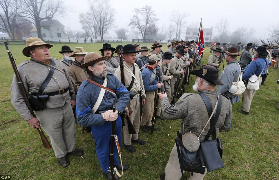 Confederate troops muster in front of the McLean House as they prepare for battle during a re-enactment of the Battle of Appomattox Courthouse
