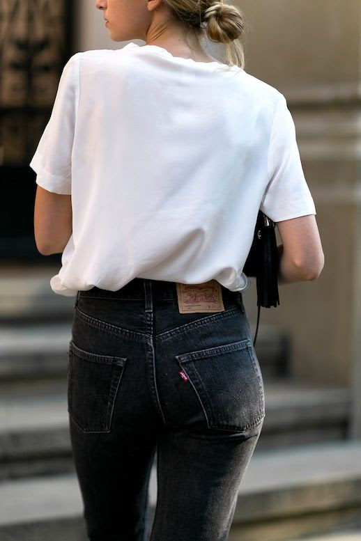 Le Fashion Blog Fall Blogger Style Blonde Low Bun Oversized White Tee Shirt Tassel Bag Faded Black Levis Jeans Via Fashion Mugging