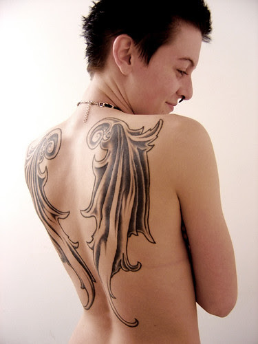 about her cross and angel wings tattoo that has the word “Daddy” written