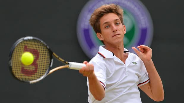 Filip Peliwo plays a forehand shot during his boys' singles final match against Australia's Luke Saville at Wimbledon in London, on Sunday.