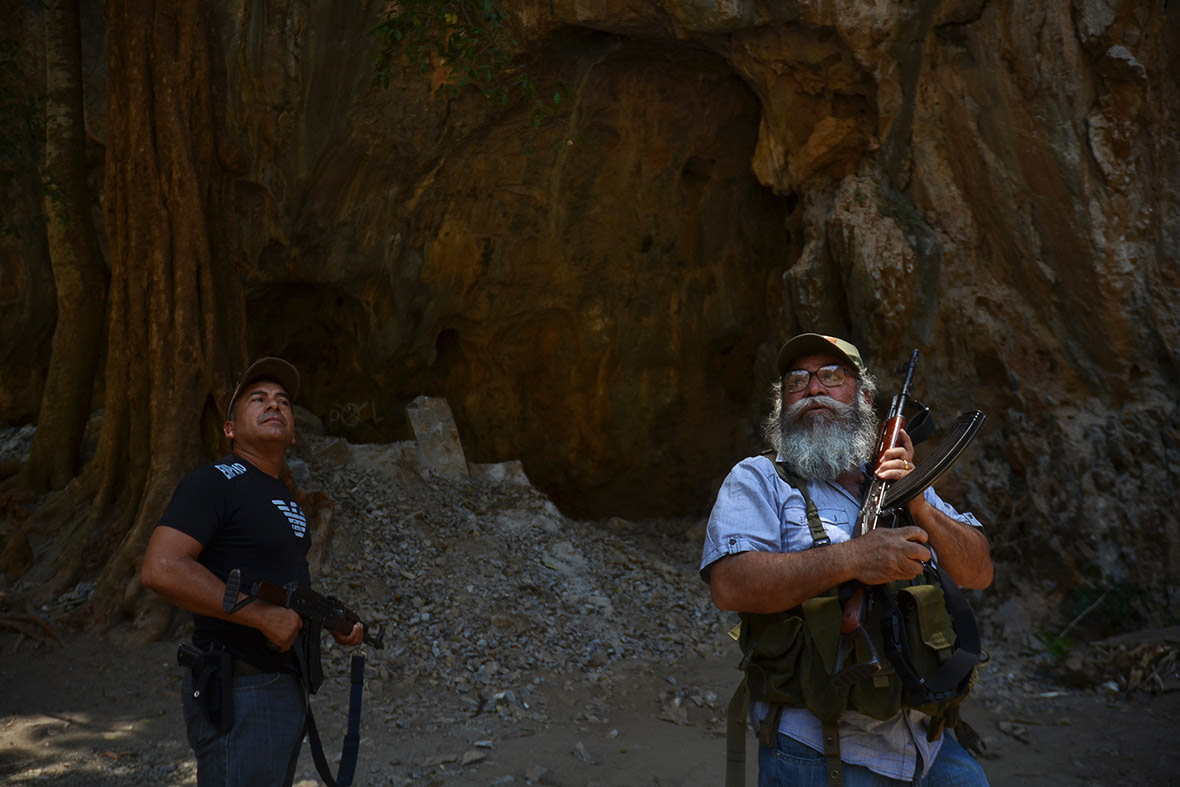 Vigilantes spokesperson Estanislao Beltran (R), known as Papa Pitufo (Papa Smurf), with a fellow vigilante