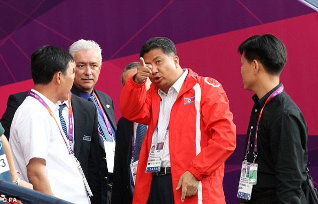 Anger: North Korean official Son Kwang Ho (second right) points furiously after the flag of arch-rivals South Korea is shown next to his players' faces by mistake