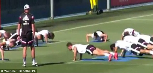 Press-ups: Ronaldo and his Madrid team-mates are put through their paces during training