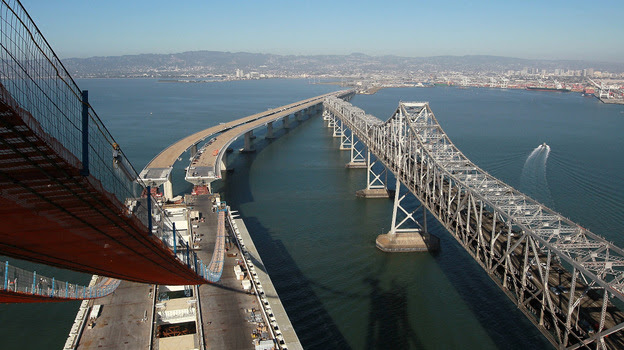 Catwalks hang over a section of the newly constructed eastern span of the San Francisco-Oakland Bay Bridge in Oakland, Calif.