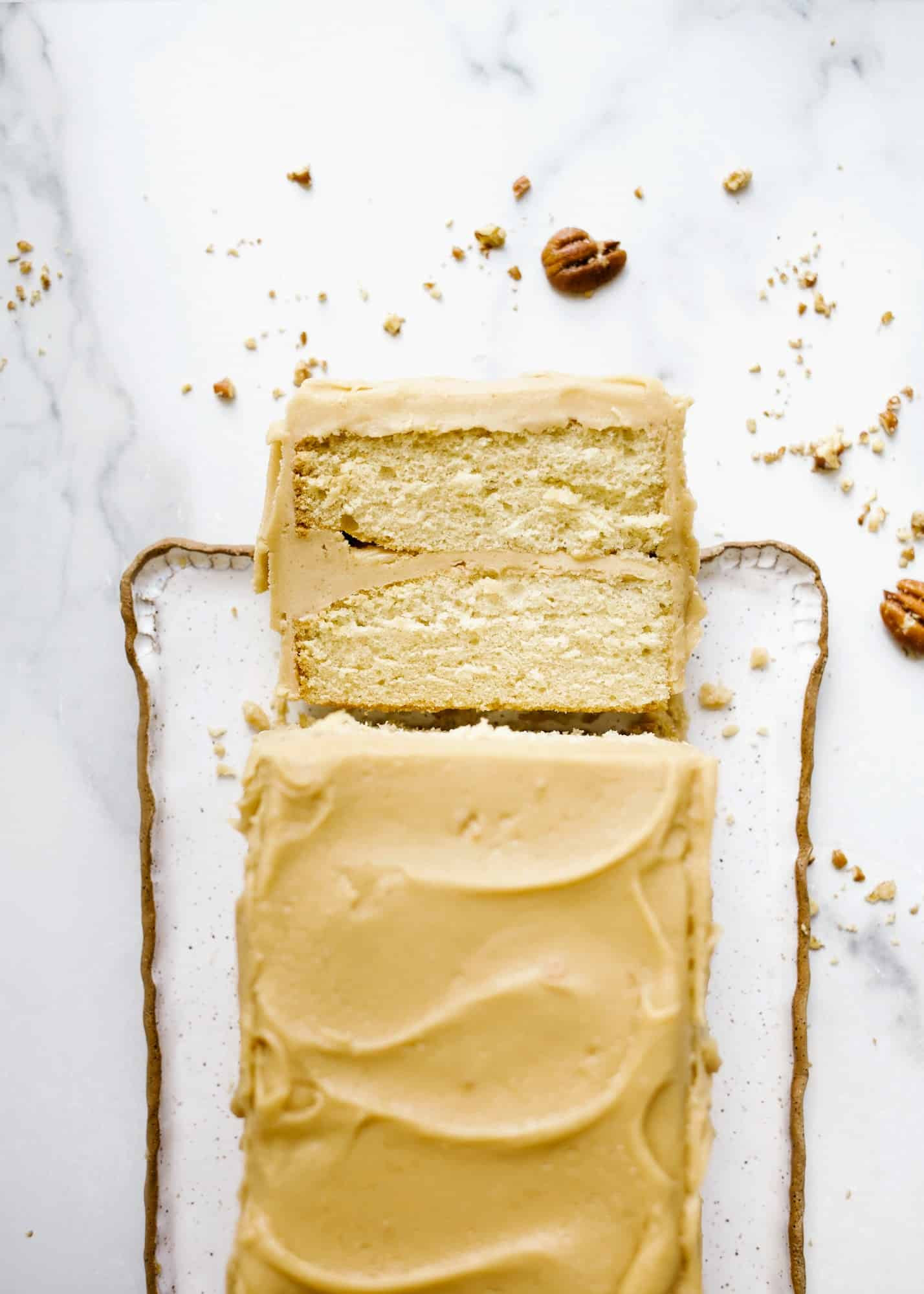 Bourbon Caramel Cake by Wood and Spoon blog. This is a fluffy brown sugar bourbon cake with a Southern old fashioned caramel frosting made with brown sugar. This is a small batch cake that only serves a few, perfect for weeknight baking. This rectangular cake makes sweet and salty layers that are perfect for fall and holiday baking. Learn how to make old fashioned icing on thewoodandspoon.com