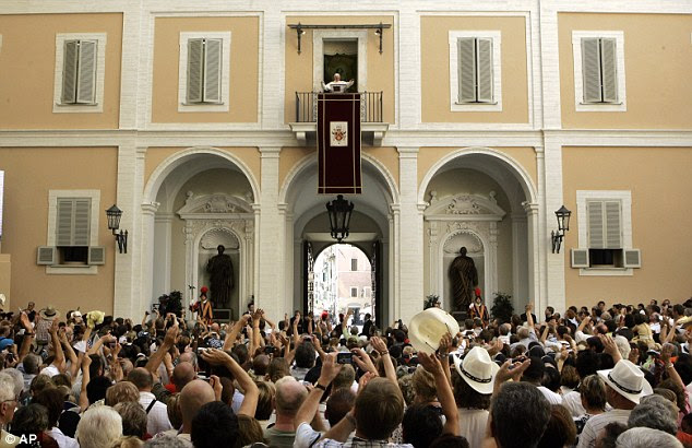Centre stage: Benedict waves to the faithful during his general audience in Castel Gandolfo in August 2009