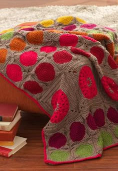 Large and small pop color circle motifs add a modern feel to this afghan. Shown in Patons Canadiana.