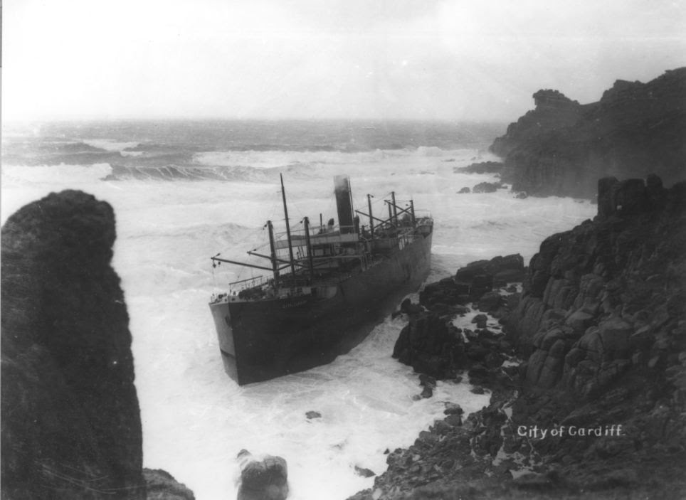 Stuck: The City of Cardiff trapped on rocks in 1912 with steam still coming out of the chimney