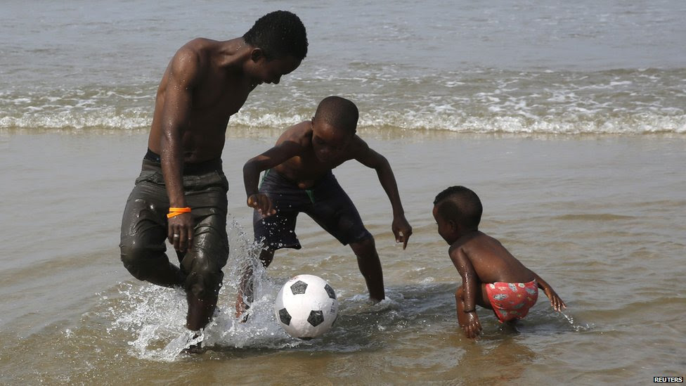 A family playing football on a beach in Bata, Equatorial Guinea - Friday 23 January 2015