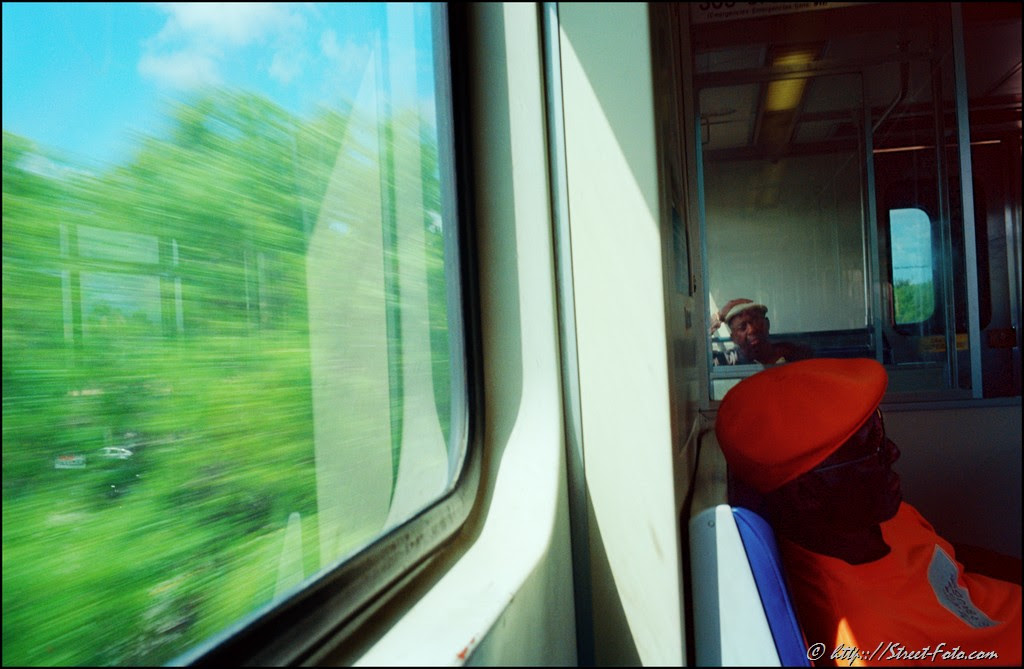 Two men riding Metrorail in Miami, Florida, USA, 2011. Street Photography of Miami, San Francisco and Key West by Emir Shabashvili, see http://street-foto.com, http://miamistreetphoto.com, http://miamistreetphotography.com or http://miamistreetphotographer.com