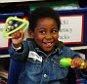 Tomi Afolabi, 4, having a music lesson at Great Ormond Street Hospital's school.   The Children's Hospital School, based at the Great Ormond Street Hospital for Children, started back in 1951 with just one teacher. Now it has a full-time staff of 30, who were delighted to receive an Ofsted report last year which judged it 'outstanding'.   If the children are still too vulnerable to go down to the classroom, the teachers go up to the wards to teach them. They wear masks, the lot, and have to wash their hands as much as a surgeon conducting an operation.  Those children's first question to the teachers is, 'When can we come  down?' says Val Miller, who is responsible for teaching Key Stages 3 and 4. 'They want to return to a semi-normal environment. They really appreciate the normality of what we do, especially if they're going through chemo. We focus on the healthy part of the child, the normal part. Everyone else here is dealing with their sickness. We treat them as pupils, not as patien