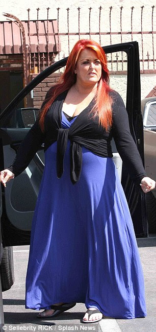 Ready to rock: Wynonna's wore her signature red locks out and flowing and donned the probably not so dance appropriate outfit of a long purple maxi dress and a black wrap long sleeved cardigan